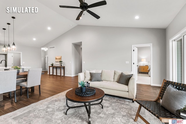 living area with a ceiling fan, visible vents, vaulted ceiling, wood finished floors, and baseboards