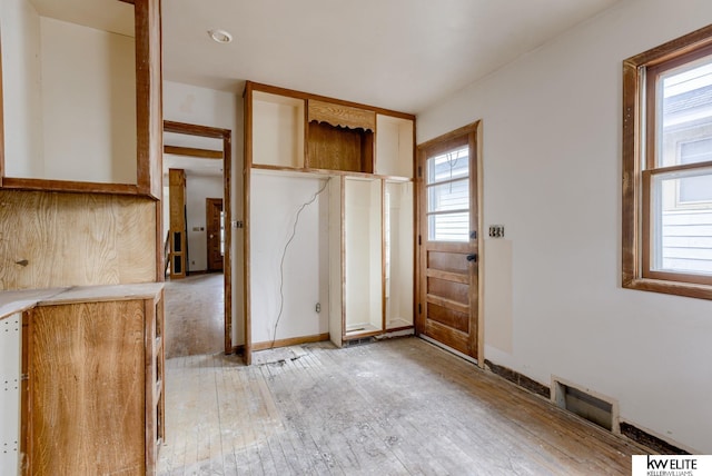 interior space with visible vents, baseboards, and light wood-style floors