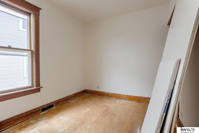 unfurnished room featuring visible vents, light wood-type flooring, and baseboards