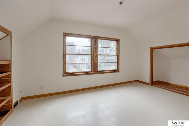 bonus room featuring lofted ceiling and baseboards