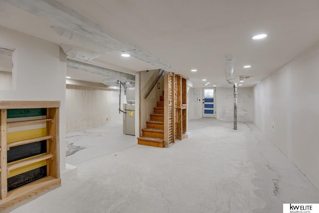basement with recessed lighting and stairs