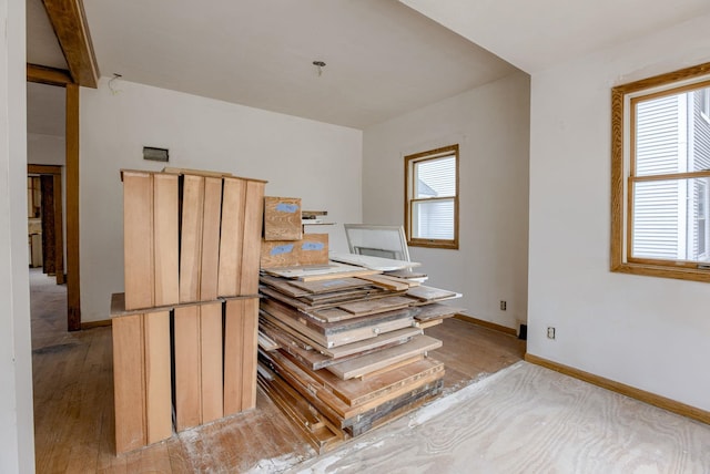 stairs with wood finished floors and baseboards