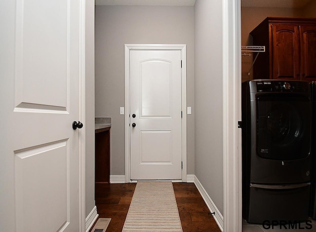 laundry room with cabinet space, washer / clothes dryer, dark wood finished floors, and baseboards