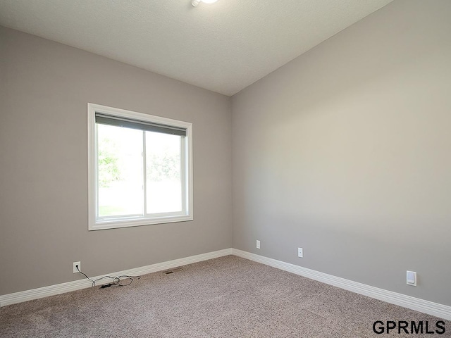 empty room with carpet flooring and baseboards
