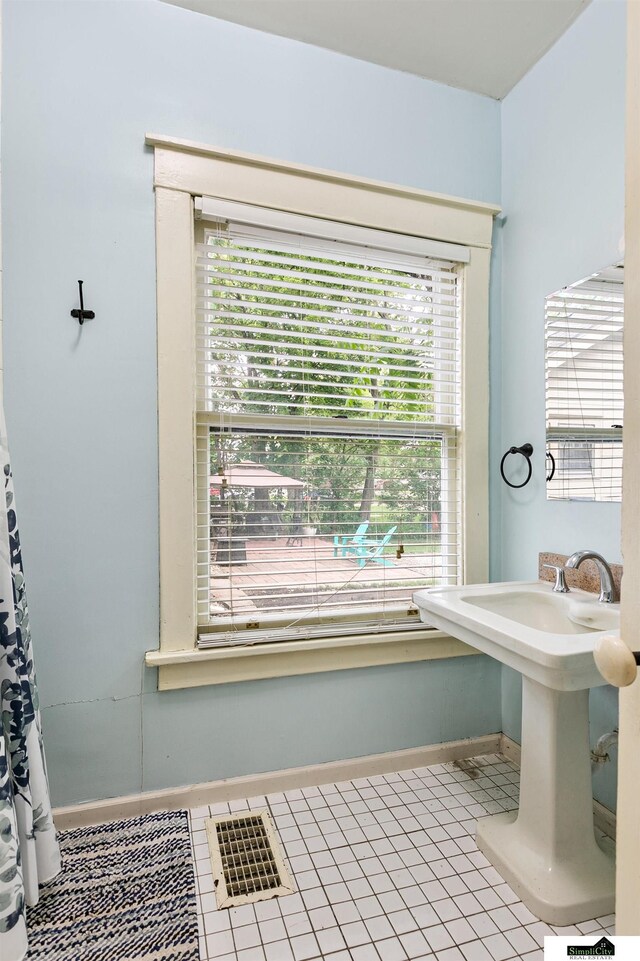 3218 Holdrege St, Lincoln, NE 68503 - bathroom with baseboards and tile patterned flooring
