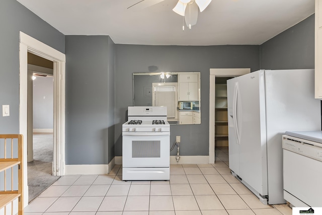 3218 Holdrege St, Lincoln, NE 68503 - kitchen with white appliances, a ceiling fan, light tile patterned floors, baseboards, and white cabinets