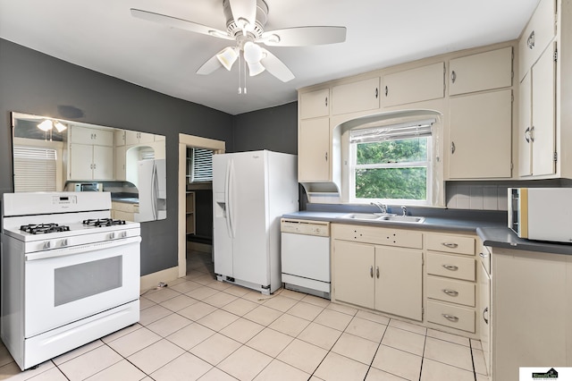 3218 Holdrege St, Lincoln, NE 68503 - kitchen featuring white appliances, a sink, ceiling fan, cream cabinets, and light tile patterned flooring
