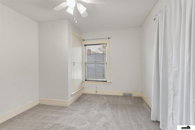 3218 Holdrege St, Lincoln, NE 68503 - empty room featuring light carpet, ceiling fan, and baseboards
