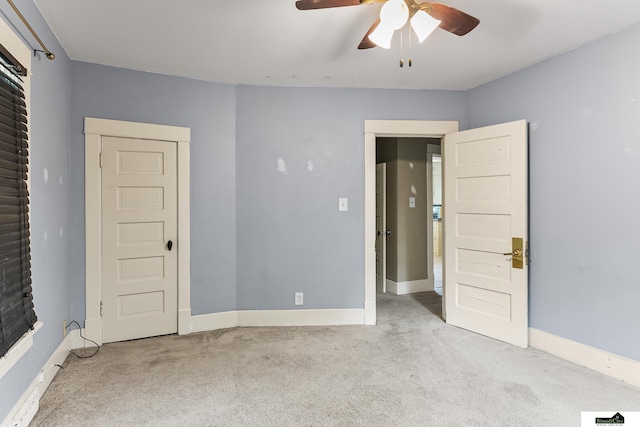 3218 Holdrege St, Lincoln, NE 68503 - unfurnished bedroom with carpet flooring, baseboards, and a ceiling fan
