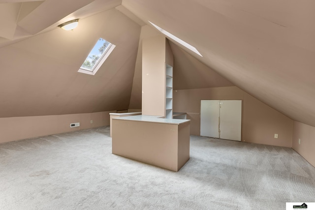 3218 Holdrege St, Lincoln, NE 68503 - additional living space with a skylight, lofted ceiling, and light colored carpet
