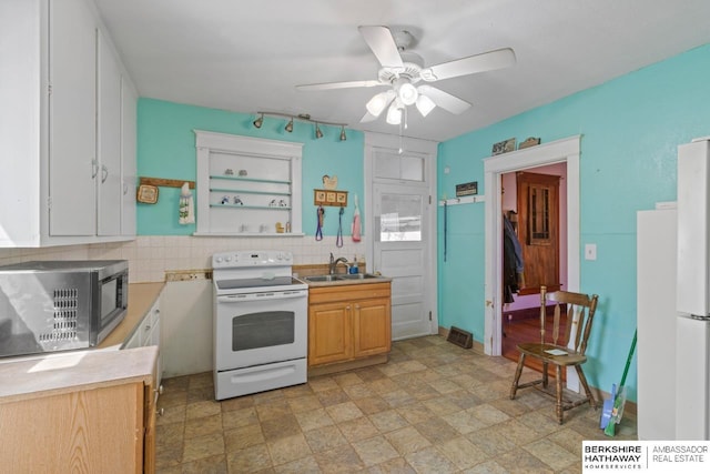 6301 SW 34th Ct, Lincoln, NE 68523 - kitchen with ceiling fan, a sink, white appliances, light countertops, and backsplash