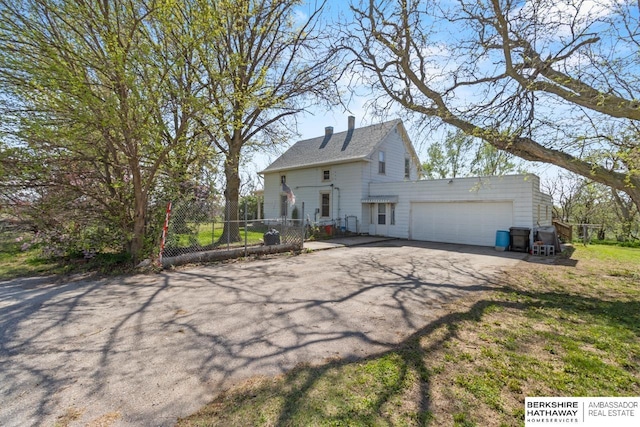 6301 SW 34th Ct, Lincoln, NE 68523 - exterior space featuring fence, driveway, a chimney, and a garage