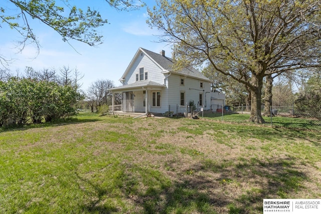 6301 SW 34th Ct, Lincoln, NE 68523 - view of side of property with a garage, fence, covered porch, a chimney, and a yard