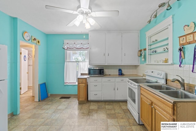 6301 SW 34th Ct, Lincoln, NE 68523 - kitchen with white range with electric stovetop, ceiling fan, a sink, stainless steel microwave, and tasteful backsplash