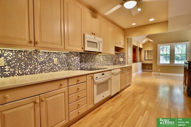 5506 Howard St, Omaha, NE 68106 - kitchen with white appliances, tasteful backsplash, light countertops, a ceiling fan, and a sink
