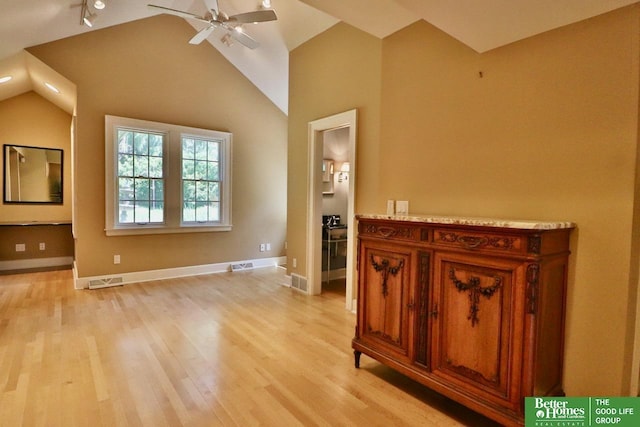 5506 Howard St, Omaha, NE 68106 - unfurnished living room featuring a ceiling fan, light wood-style floors, vaulted ceiling, and baseboards