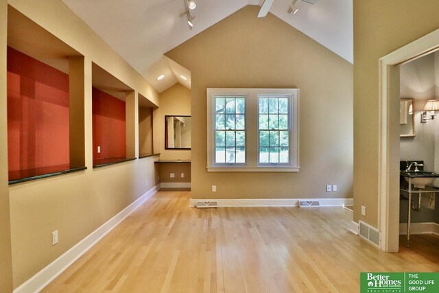 5506 Howard St, Omaha, NE 68106 - additional living space with wood finished floors, lofted ceiling, and baseboards