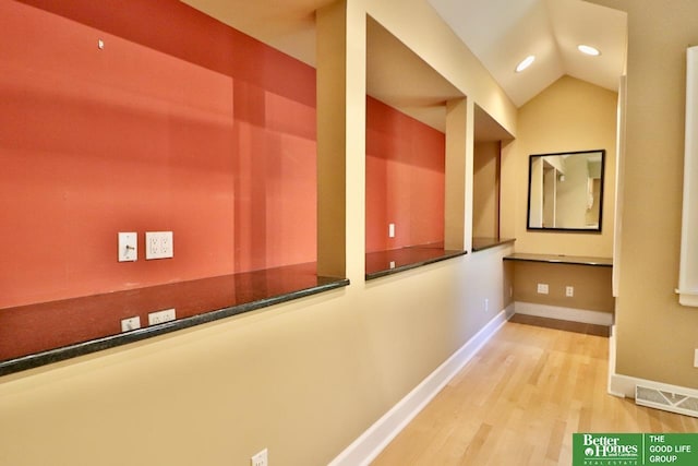 5506 Howard St, Omaha, NE 68106 - corridor featuring wood finished floors, recessed lighting, baseboards, and vaulted ceiling