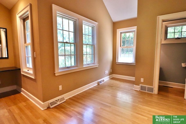 5506 Howard St, Omaha, NE 68106 - entryway featuring light wood-style flooring, baseboards, and vaulted ceiling