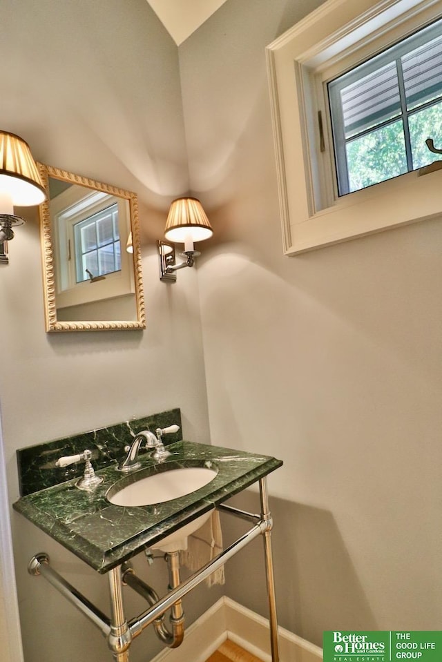 5506 Howard St, Omaha, NE 68106 - bathroom with a sink and vaulted ceiling