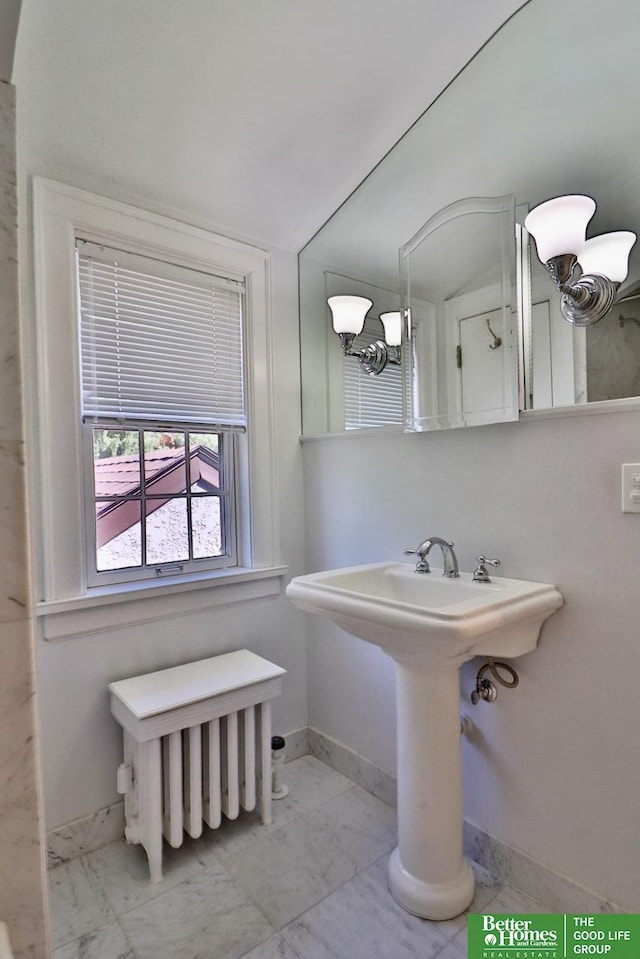 5506 Howard St, Omaha, NE 68106 - bathroom with marble finish flooring, baseboards, radiator, and a sink