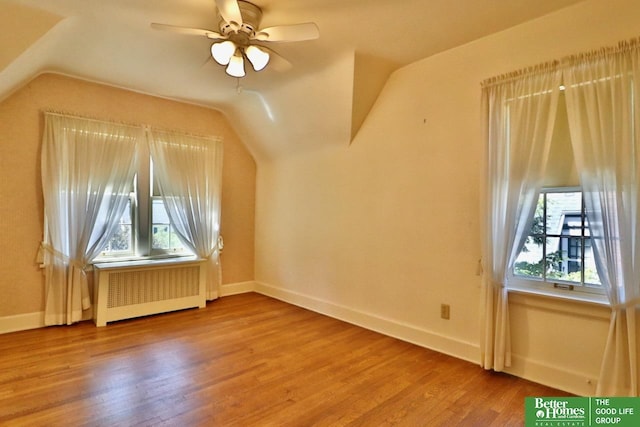 5506 Howard St, Omaha, NE 68106 - bonus room with radiator heating unit, vaulted ceiling, wood finished floors, ceiling fan, and baseboards