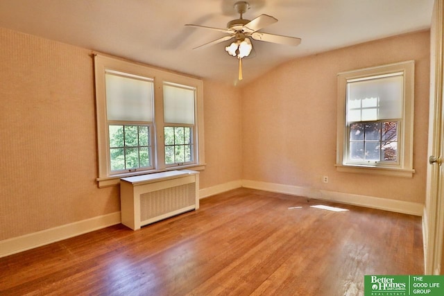 5506 Howard St, Omaha, NE 68106 - empty room with wood finished floors, a ceiling fan, baseboards, and radiator heating unit