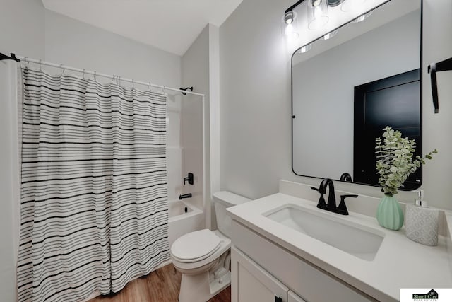 bathroom with toilet, shower / bath combo with shower curtain, wood finished floors, and vanity