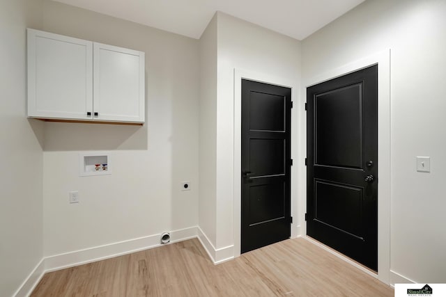 clothes washing area featuring baseboards, cabinet space, hookup for an electric dryer, light wood-style flooring, and washer hookup