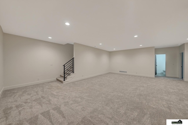 interior space featuring recessed lighting, light carpet, stairs, and visible vents