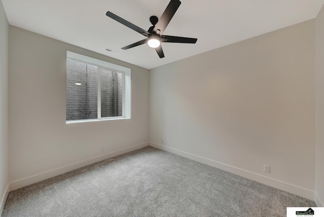 carpeted empty room with baseboards, ceiling fan, and visible vents