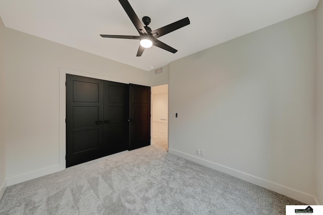 unfurnished bedroom with baseboards, ceiling fan, carpet flooring, and visible vents