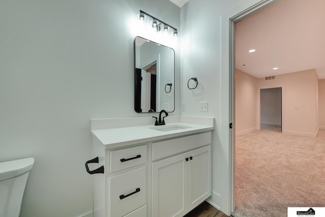 bathroom featuring vanity, toilet, recessed lighting, baseboards, and visible vents