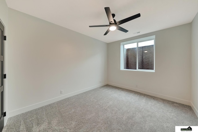 unfurnished room featuring carpet flooring, ceiling fan, visible vents, and baseboards