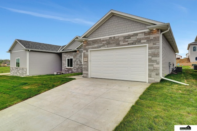 view of front of home featuring a garage, a front yard, stone siding, and concrete driveway