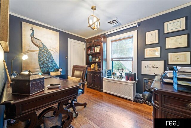 home office featuring crown molding, visible vents, and wood finished floors