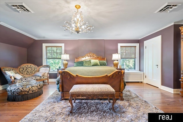 bedroom featuring an inviting chandelier, visible vents, wood finished floors, and baseboards
