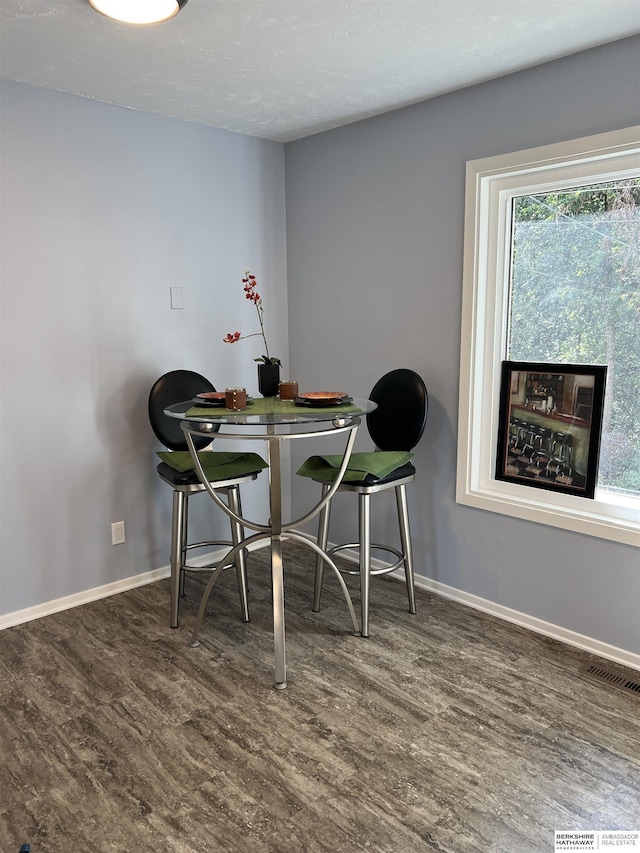 dining area featuring a healthy amount of sunlight, baseboards, and wood finished floors