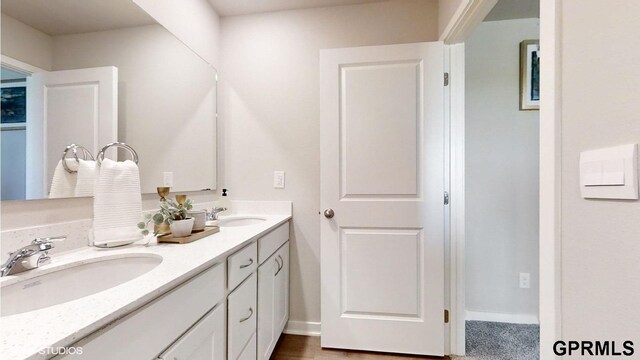 full bath with double vanity and a sink