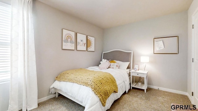 bedroom with baseboards and carpet