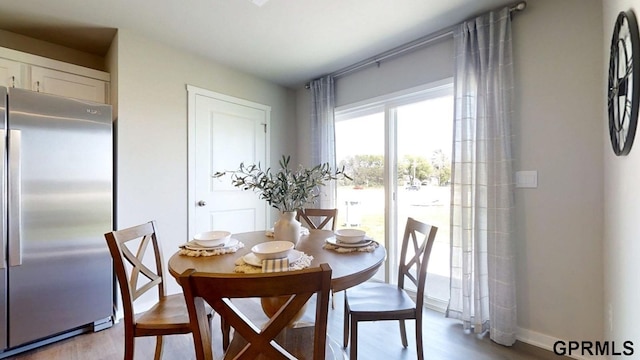 dining area featuring baseboards and wood finished floors