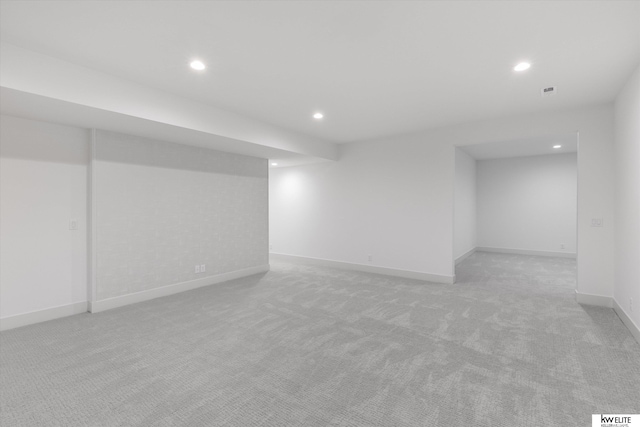 finished basement with light carpet, recessed lighting, and baseboards