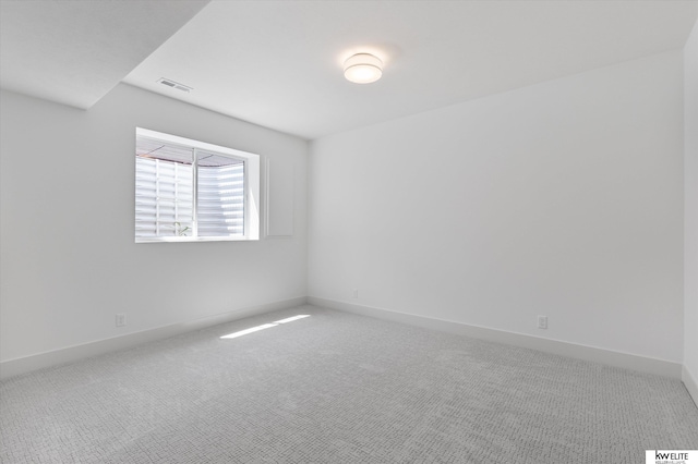 unfurnished room with carpet flooring and baseboards
