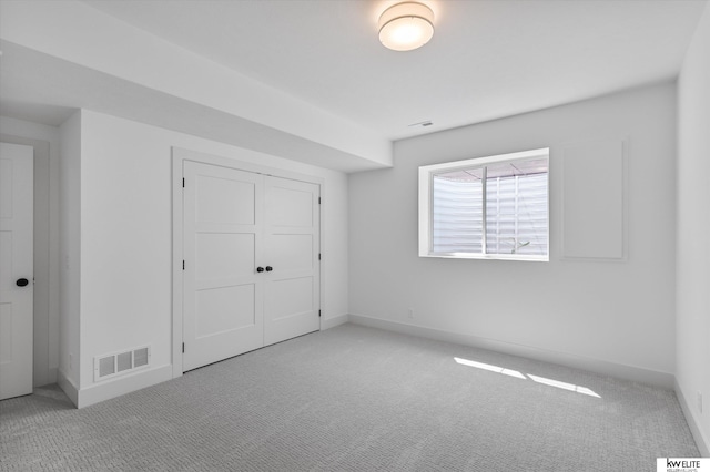 unfurnished bedroom with carpet, baseboards, and a closet