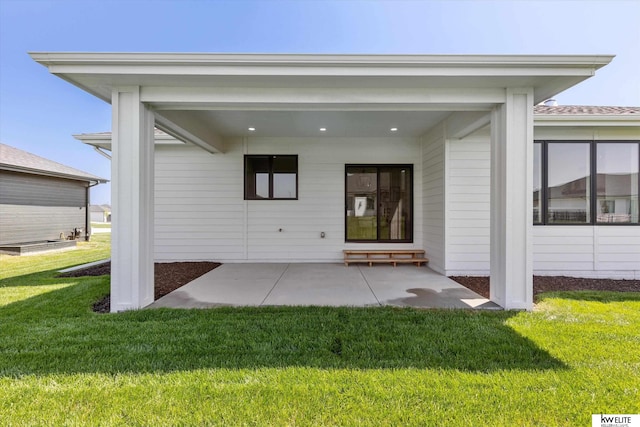 rear view of property featuring a lawn