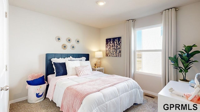 bedroom featuring baseboards, carpet flooring, and visible vents