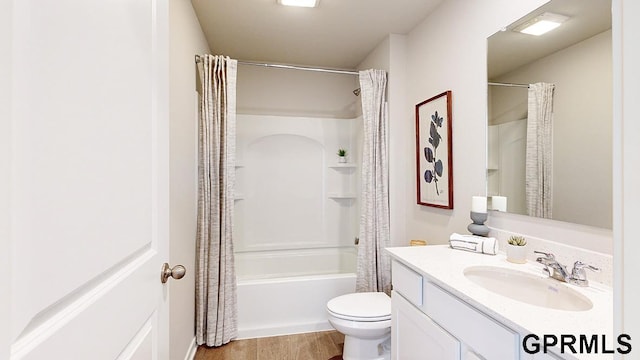 full bathroom with toilet, wood finished floors, shower / tub combo with curtain, and vanity