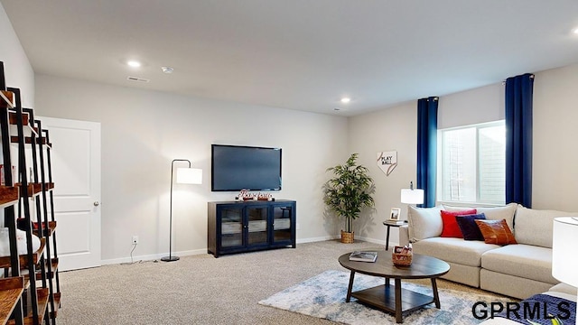 living room with recessed lighting, baseboards, and carpet