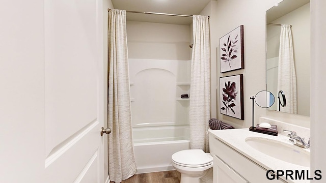 full bathroom featuring vanity, wood finished floors, shower / bath combo, and toilet