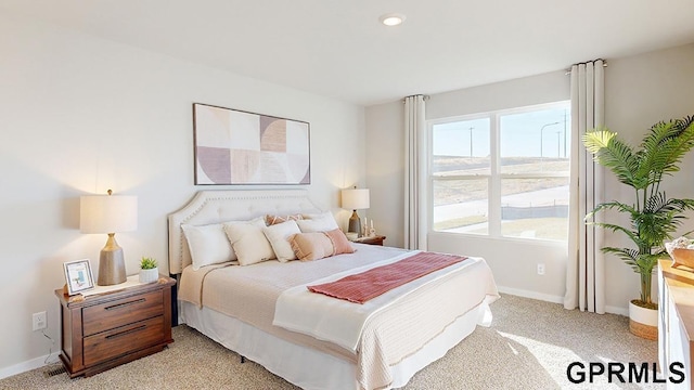 bedroom featuring light colored carpet, recessed lighting, and baseboards
